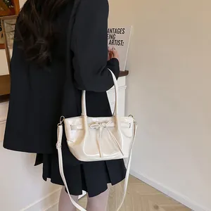 Chic cream white bucket bag with bow detail and adjustable strap for women