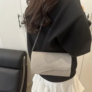 Elegant silver glitter crossbody square bag with fine chain strap and metallic finish