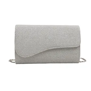 Silver glitter evening clutch bag with wavy flap design and slim metal chain strap