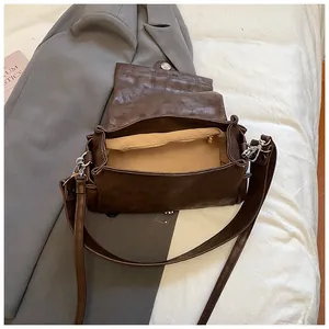 Minimalist brown shoulder bag with spacious interior and inner zipper pocket