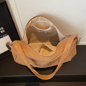 Retro large brown leather shoulder bag with wide strap and spacious interior