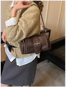 Detail of coffee brown faux leather shoulder bag featuring vintage crinkled texture