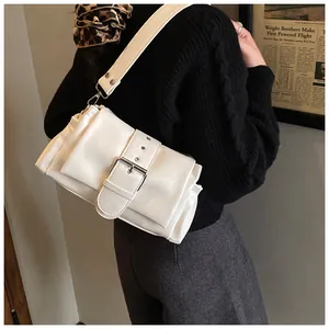 Detail of off-white crossbody bag with large buckle strap and pleated cloud style texture