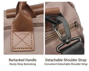 Detail view of reinforced handle cross-stitching and detachable shoulder strap on travel bag