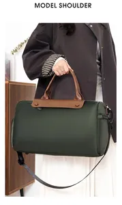 Model display of large waterproof nylon travel bag with brown leather handles and strap