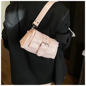 Detail of light pink shoulder bag with large silver buckle on glossy faux leather finish