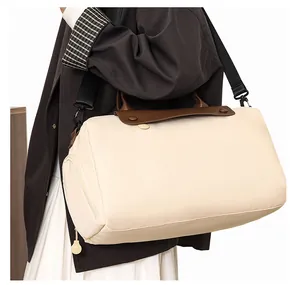 Large cream travel bag with brown leather flap shown in lifestyle model shot