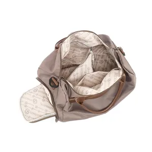 Large khaki travel fitness bag with brown leather handles and spacious interior