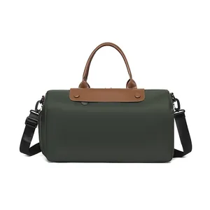 Green nylon travel fitness bag with brown leather handles and adjustable shoulder strap
