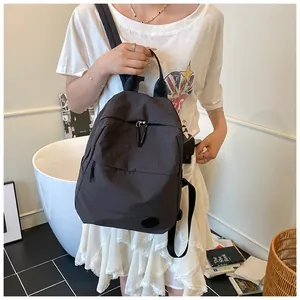 Dettaglio dello zaino minimalista grigio scuro con spallacci regolabili in nylon liscio