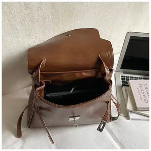 Vintage brown leather shoulder bag with large capacity and silver twist lock closure