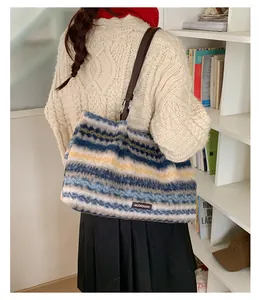 Detail of plush striped tote bag with soft texture and dark brown shoulder strap