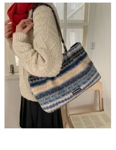 Detail of plush tote bag with multi-color stripes and leather strap on model
