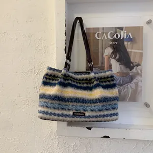 Detail showing the plush faux fur texture and striped wavy pattern of the tote bag
