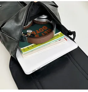 Detail view of large capacity black leather backpack holding a laptop and headphones