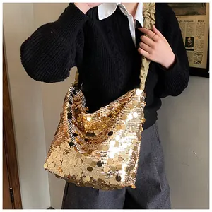 Detail of large gold sequin tote bag showing sparkling texture and pleated strap detail
