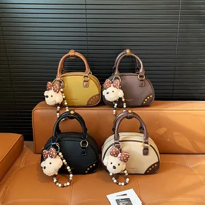 Vintage faux suede Boston handbags in yellow, brown, black and cream with charms