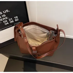 Top view of brown leather bucket bag showing spacious interior with zipper compartment