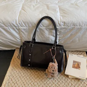Deep brown glossy leather tote bag with silver studs and cute plush puppy charm