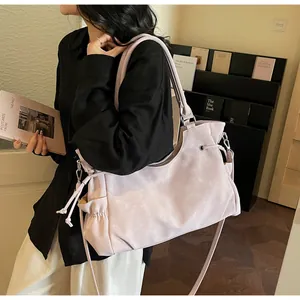 Close-up of lilac PU leather tote with drawstring details and adjustable crossbody strap
