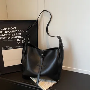 Classic black hobo shoulder bag in matte leather featuring vertical belt and metal buckle