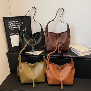 Vintage leather tote bags in four colors shown on a display stand for women
