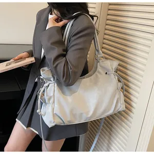 Detail of light blue pleated hobo bag with drawstring and side pocket for women