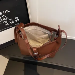 Vintage brown faux leather tote bag with spacious interior and adjustable strap