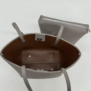 Taupe textured leather tote bag set with a matching small zipper pouch on a white background