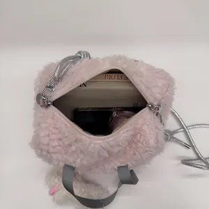 Pink plush satchel bag with silver rope strap showing spacious daily storage interior