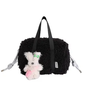 Fashionable black plush sherpa pillow bag with a cute white bunny charm and silver details