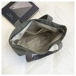 Deep grey canvas tote bag featuring a spacious interior with multiple storage pockets