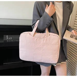 Detailed texture of light pink quilted nylon handbag for commuting and daily use