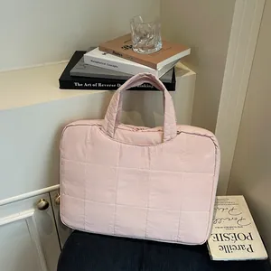 Chic pink quilted handbag for women featuring a sleek top handle and zip closure