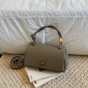 Chic grey litchi grain leather handbag with knotted handle and gold swivel lock