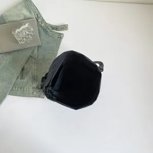 Black techwear canvas crossbody bag with spacious interior and waterproof nylon fabric