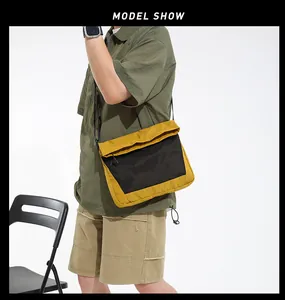 Detail of yellow nylon messenger bag with black mesh pocket and adjustable shoulder strap