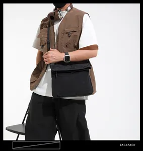Close-up of black waterproof canvas messenger bag with functional minimalist flap and strap