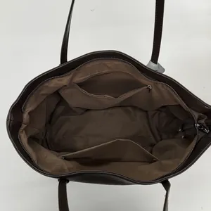 Minimalist large brown tote bag with zipper closure and spacious interior compartments