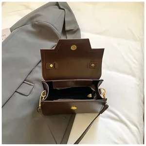 Retro dark brown leather square handbag with golden magnetic closure and crossbody strap