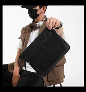 Close-up of black functional messenger bag with breathable mesh front and adjustable strap