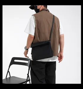 Rear view of a black techwear canvas crossbody bag on a model for daily commuting