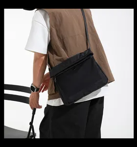 Detail view of techwear crossbody bag with breathable black mesh pocket and nylon strap