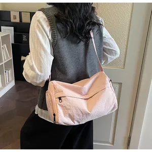 Detail of pink vintage crossbody bag with side zipper and adjustable shoulder strap