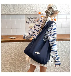 Detailansicht der großen marineblauen Segeltuch-Tote-Bag mit kleinem weißen Etikett