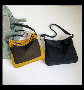 Detailed comparison of yellow and black techwear canvas messenger bags with mesh pocket details