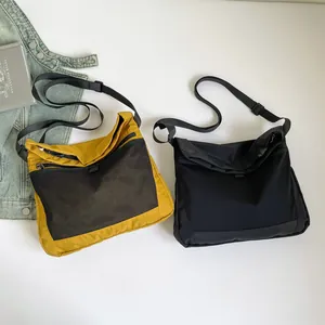 Nylon techwear crossbody bags in yellow and black with mesh pockets for commuting