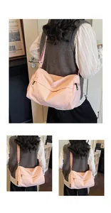 Detailed view of pink large capacity nylon crossbody bag with natural crinkled texture