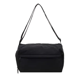 Minimalist black crossbody bag with adjustable strap and multiple zipper pockets for women
