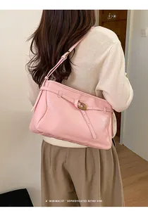 Detail of pink vintage shoulder bag with textured leather and gold spiral buckle
